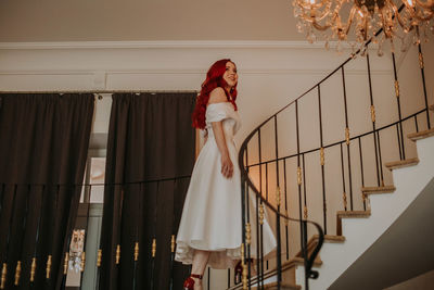 Woman standing by railing