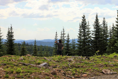 Rear view of hiker looking at view from mountain top