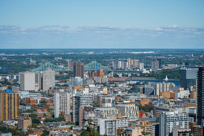 High angle view of buildings in city against sky