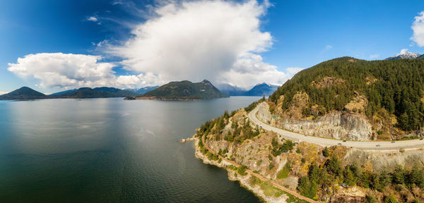 Panoramic view of sea and mountains against sky