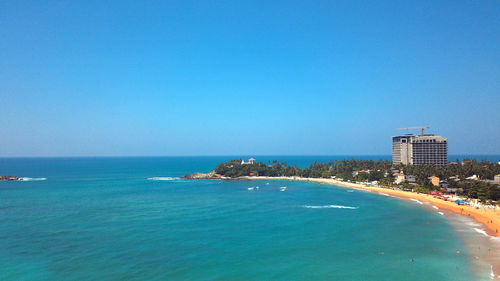 Scenic view of sea against clear blue sky