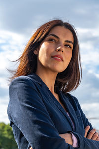 Low angle view of woman looking away against sky