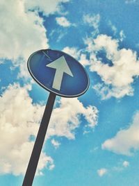 Low angle view of road sign against sky