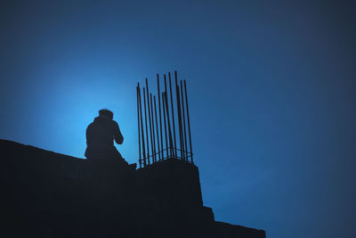 Silhouette man standing against clear blue sky
