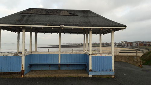 Built structure on beach against sky