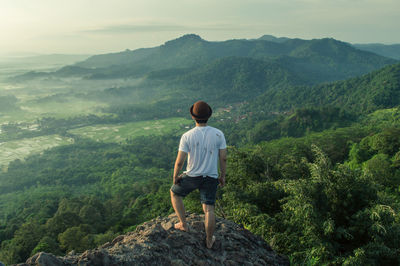 Woman looking at mountain landscape