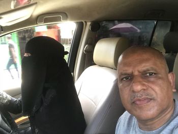 Portrait of man sitting in car