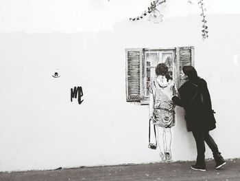 Full length of woman standing by railing