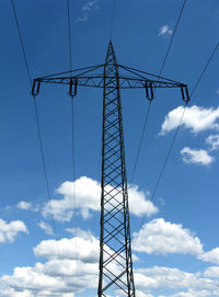Low angle view of electricity pylon against sky