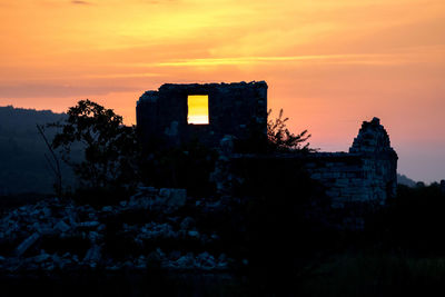 Low angle view of silhouette building against sky