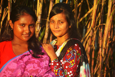 Portrait of smiling women standing outdoors