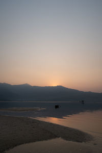 Scenic view of sea against clear sky during sunset