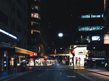 Illuminated city street at night