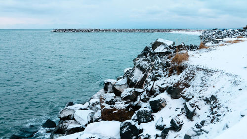 Scenic view of sea against sky during winter