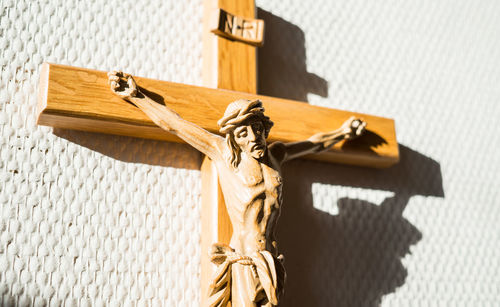 Statue of crucifix against wall