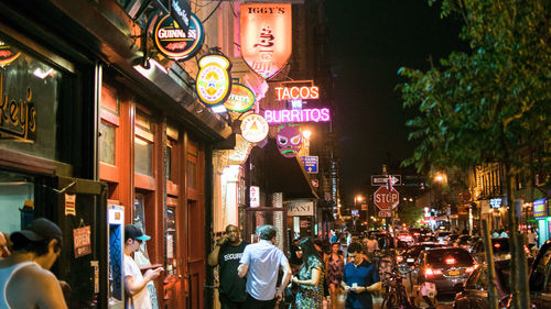 People walking in city at night