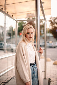 Portrait of beautiful woman standing in bus