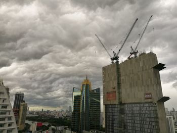 Low angle view of cranes against sky