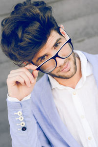 Portrait of young man wearing eyeglasses while standing outdoors