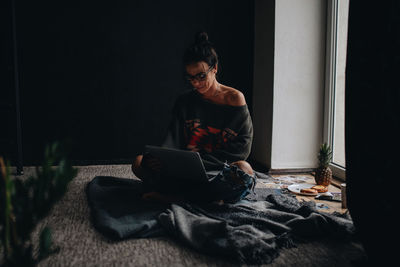 Woman using laptop at home