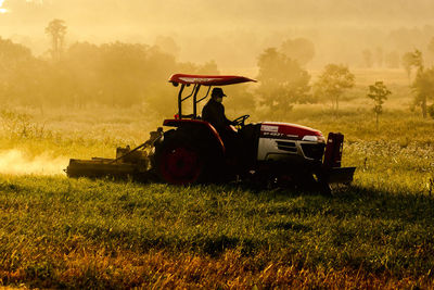 Tractor on field against sky