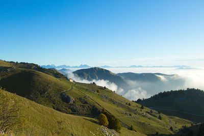 Scenic view of mountains against clear blue sky