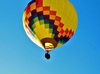 Low angle view of hot air balloon against clear blue sky