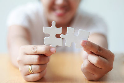 Close-up of man playing with hands