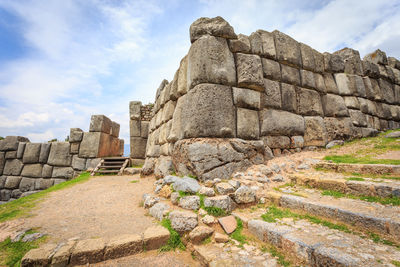 Ruins of temple against cloudy sky