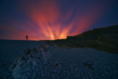 Scenic view of rocks against sky during sunset