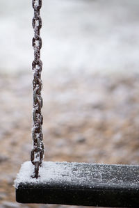 Close-up of chain against water
