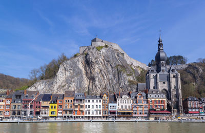 View of dinant waterfront with citadel on the top of cliff