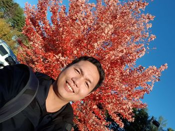 Portrait of smiling young woman with autumn leaves