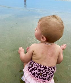 High angle view of shirtless baby boy in water