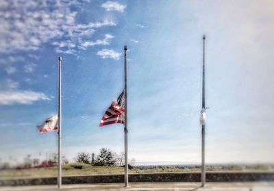 Flags on pole against sky