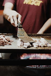 Close-up of person preparing food on table