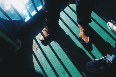 Low section of man walking on tiled floor