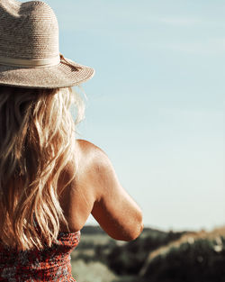 Rear view of woman looking at camera