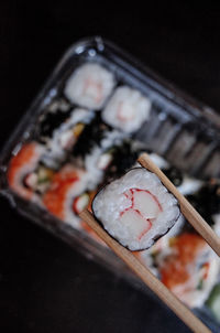 Close-up of chopsticks with sushi