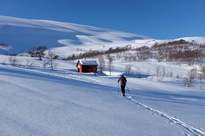 People walking on snow covered field