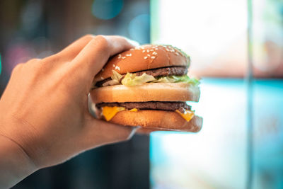 Close-up of hand holding burger