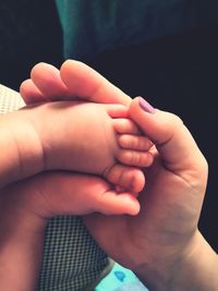 Close-up of hands holding baby hand