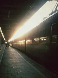 Man on illuminated railroad station platform