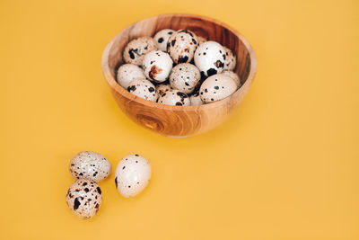 Directly above shot of eggs on yellow background