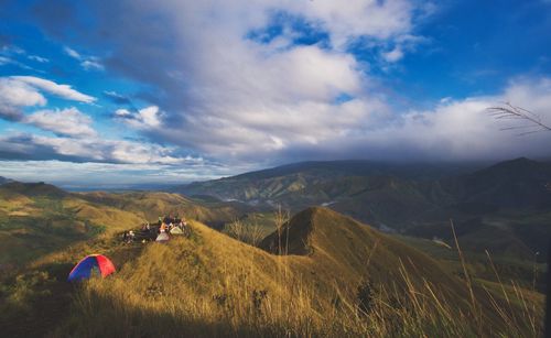 Scenic view of land and mountains against sky