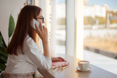 Woman and coffee cup on table