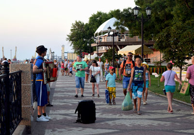 People standing on street against sky