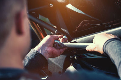 Close-up of man repairing bicycle