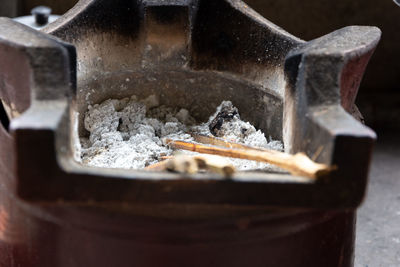 Close-up of ash in container