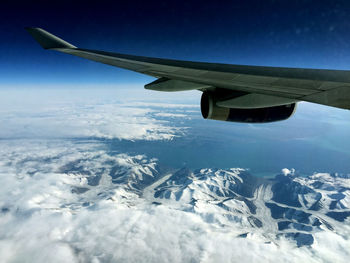 Aerial view of snowcapped mountain against sky